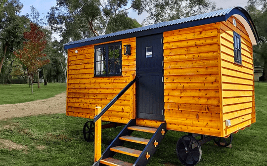 Bright yellow compact cabin on wheels at Eldorado Caravan Park