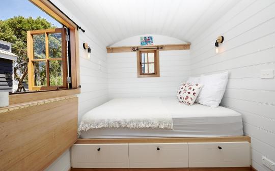 Cozy sleeping nook with ample storage in a park cabin